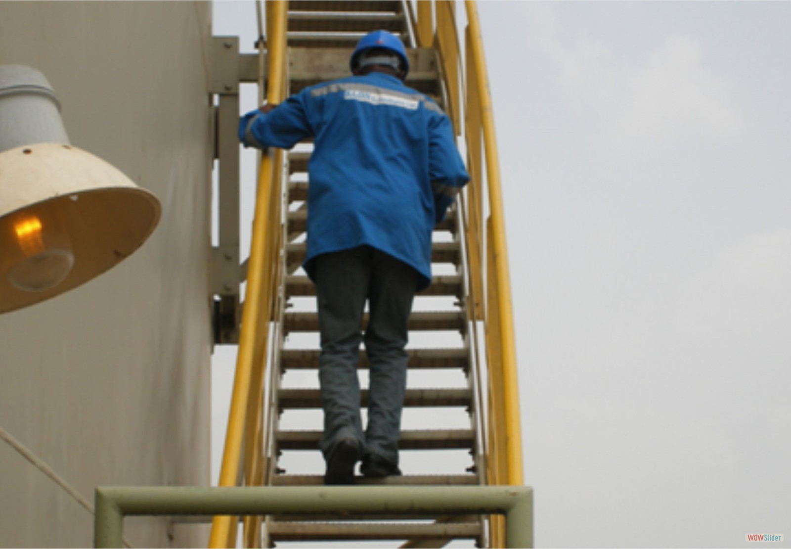 Engineer accessing roof of tank